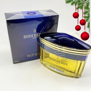 May include: A blue and gold bottle of Boucheron Paris Eau de Toilette Pour Homme cologne. The bottle is 125 ml.