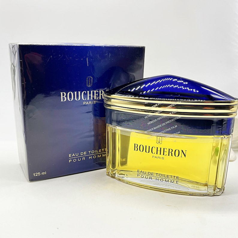 May include: A blue and gold bottle of Boucheron Paris Eau de Toilette Pour Homme, a men's fragrance. The bottle is 125 ml.