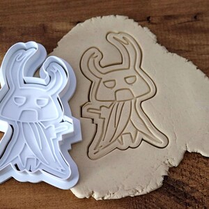 May include: A set of three ceramic mugs with a speckled, matte finish. The mugs are in shades of cream, light gray, and dark gray. Each mug has a simple, minimalist design, perfect for coffee or tea.