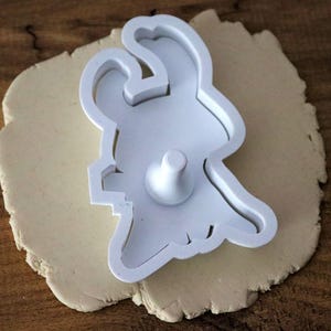 May include: A set of three ceramic mugs with a speckled, matte finish. The mugs are in shades of cream, light gray, and dark gray. Each mug has a simple, minimalist design and a rounded handle.