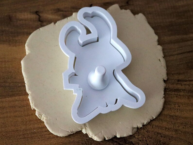 May include: A set of three ceramic mugs with a speckled, matte finish. The mugs are in shades of cream, light gray, and dark gray. Each mug has a simple, minimalist design and a rounded handle.