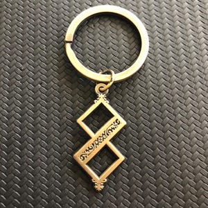 Twisted One Symbol - Blasphemous Inspired Double-sided Keychain