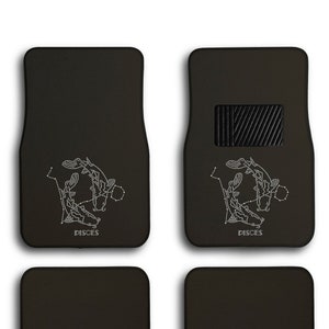May include: Set of four black car floor mats with a white Pisces zodiac constellation design. The front mats have a black rubber heel rest.