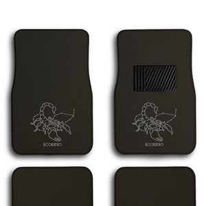 May include: Set of four black car floor mats with a white scorpion constellation design and the word "SCORPIO" printed on the front two mats.