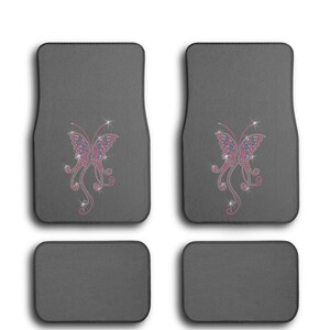 May include: Set of four gray car floor mats with a pink and blue butterfly design on two of the mats.