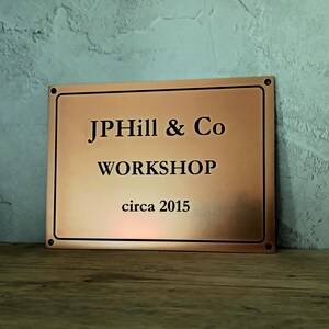 Bronze signage made to order with engraved custom text and border.
