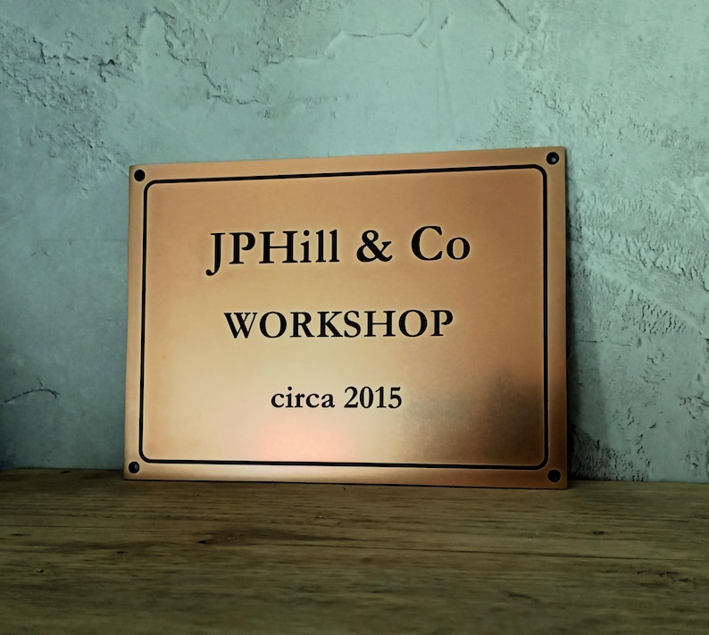 Bronze signage made to order with engraved custom text and border.