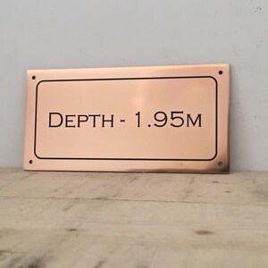 Bronze custom depth sign, solid bronze plaque with personalised lettering, numbering and border.