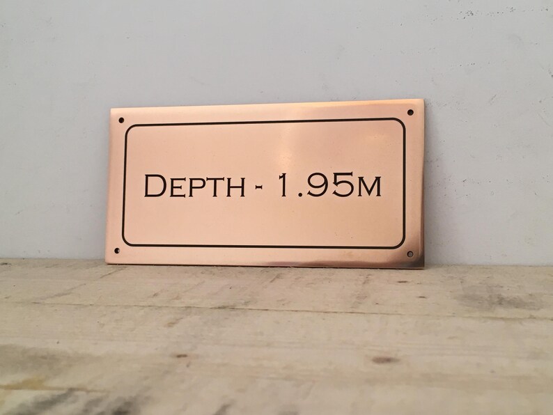 Bronze custom depth sign, solid bronze plaque with personalised lettering, numbering and border.