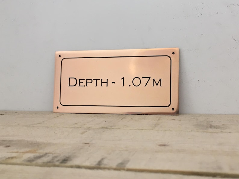 Bronze pool depth plaque.