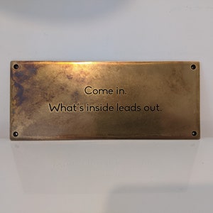 Aged brass plaque with custom text and patina finish