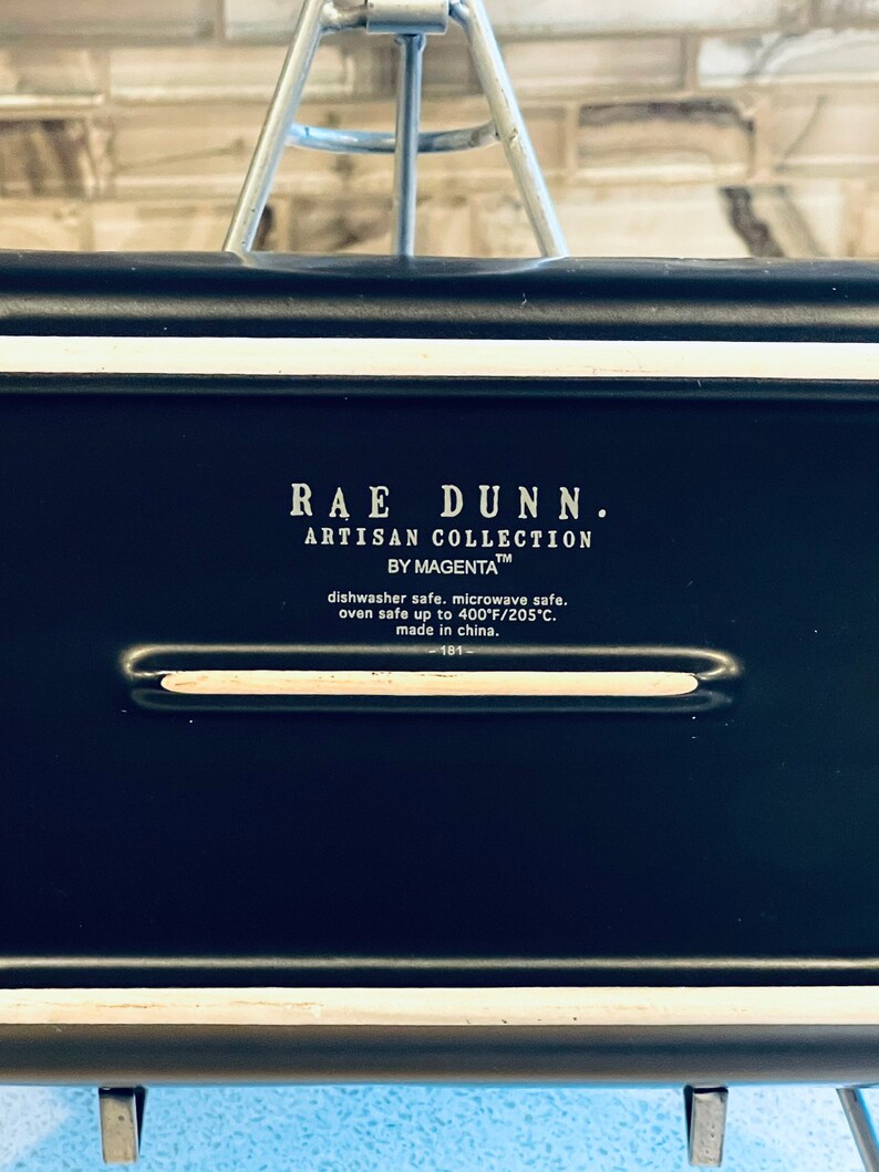 May include: Black Rae Dunn Artisan Collection by Magenta dish with white lettering. Dishwasher, microwave, and oven safe up to 400 degrees Fahrenheit or 205 degrees Celsius. Made in China.