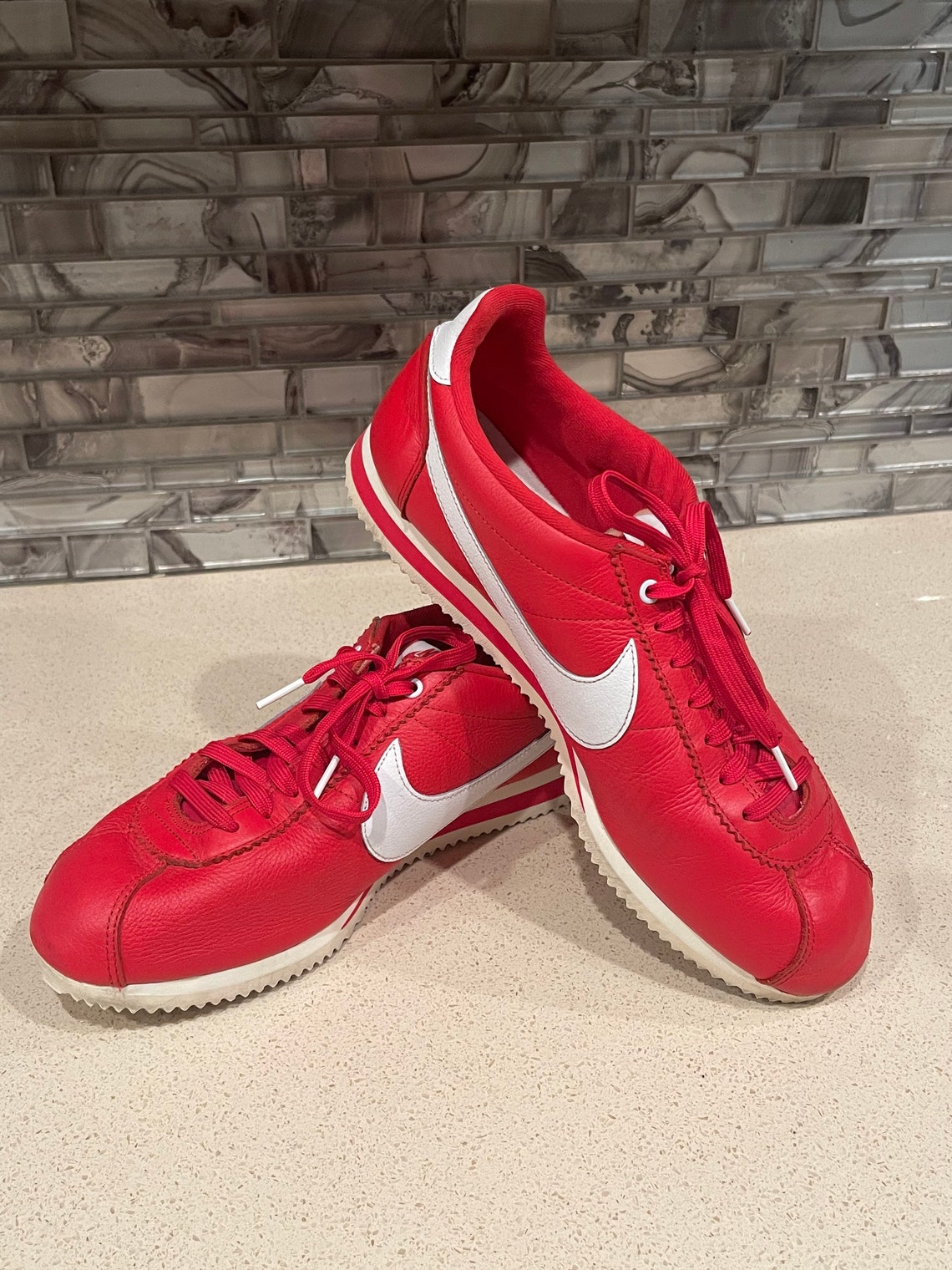 white nike shoe with red swoosh