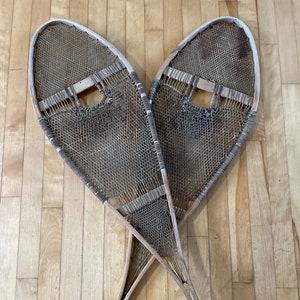 A pair of vintage native  12 by 41 snow shoes made in Canada.