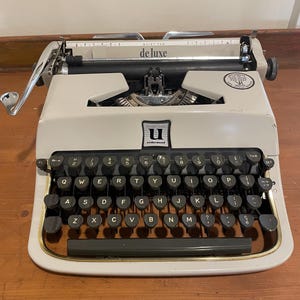 Vintage Underwood De Luxe Portable Typewriter with a Golden touch keyboard