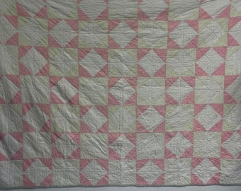 Pink and white hand stitched geometric quilt