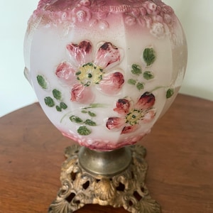 A beautiful red and white cosmos floral gone with the wind lamp base that has been professionally electrified.