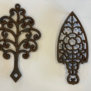 Two Antique footed cast iron trivets