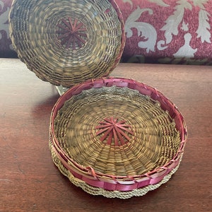 A rare round vintage ash strip basket covered with sweet grass and twine.