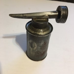 Unusual little oil tin with screw top and screw on spout joined together for easy finding and use.