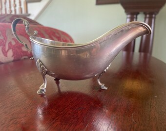 RYRIF sterling gravy boat circa 1895 with some denting including at a leg top
