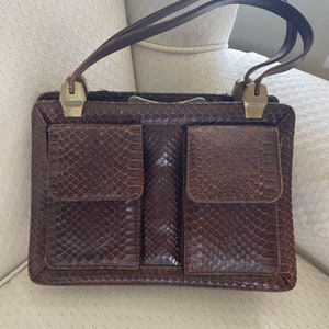 A nice vintage snakeskin leather purse with side pockets.