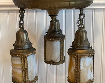 A gorgeous antique 1920's 4 arm pan light with original rounded caramel glass shades