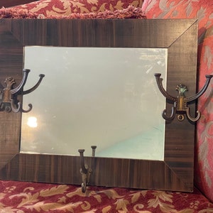 Wood framed mission style mirror with the original hooks in good condition