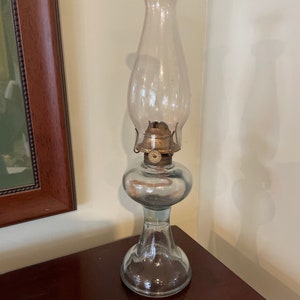 An antique glass base oil lamp in good &quot;as found&quot; condition complete with wick and chimney..
