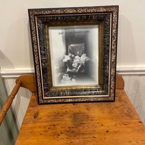 A wonderful circa 1900 Eastlake style black ebonized and gilt gold incised picture frame with glass and a newer picture.