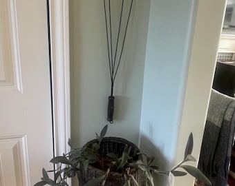 Primitive wire rug beater with wooden handle