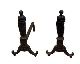 A pair of early antique forged African American cast iron andirons in good condition.