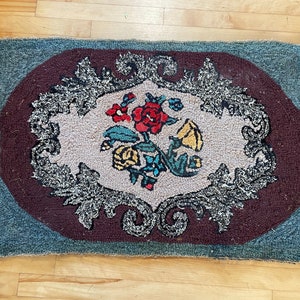 A nice floral heavy hand hooked rug in good shape from the 1950&#39;s.  #14