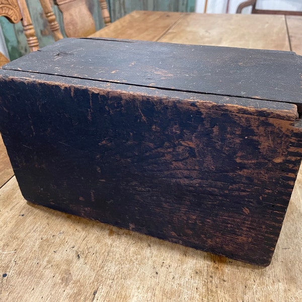 An early small pine candle box with cover in original brown finish.