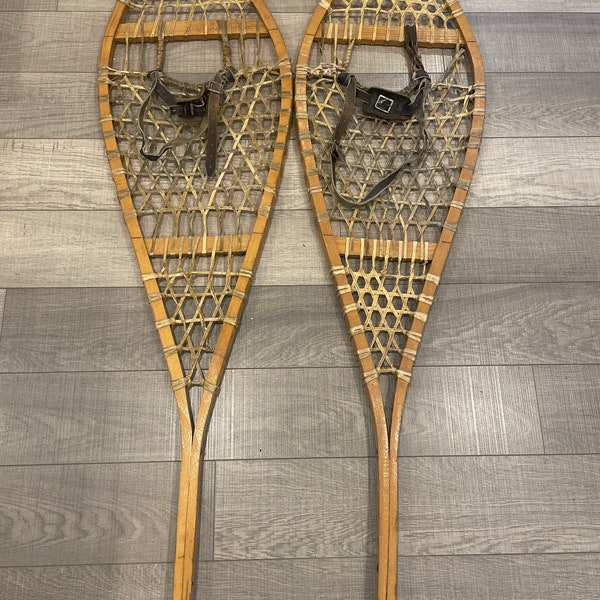 A nice pair of vintage   14 by 48 snow shoes made in Canada.