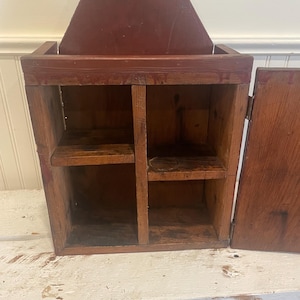 Beautiful primitive pine wall cupboard in great red paint.