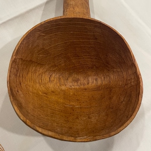 An antique hand carved serving spoon/ladle in good vintage condition.