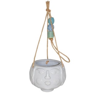 May include: White ceramic hanging planter shaped like a face with a rope hanger and blue and green beads.