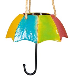 May include: A colorful ceramic umbrella-shaped hanging planter with a black metal hook. The planter is painted in shades of yellow, green, blue, and red.