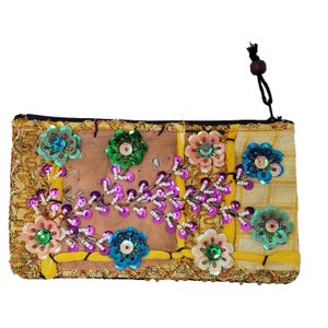 May include: A yellow fabric pouch with a zipper closure and a beaded floral design. The pouch is decorated with sequins and beads in various colors, including pink, green, blue, and gold.