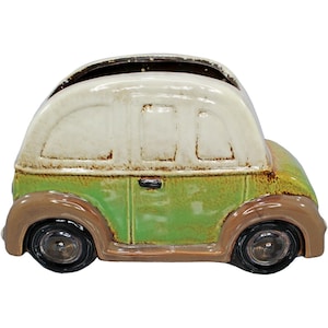 May include: A green and brown ceramic planter shaped like a vintage car. The car has a white roof and brown wheels.