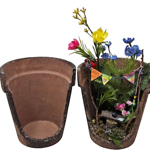 May include: A terracotta flower pot with a miniature fairy garden inside. The garden features a small wooden bench, a tiny house, and colorful flowers. The pot is broken in half, revealing the miniature garden inside.