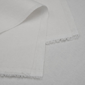 May include: White fabric with a raw edge. The fabric is folded over and the edges are visible.