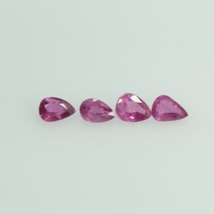 May include: Four pear-shaped, vibrant pink gemstones are arranged horizontally against a white background. The gems have a polished, reflective surface, showcasing their clarity and color. These gemstones are ideal for jewelry making.