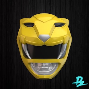 May include: A bright yellow helmet featuring a stylized feline design with a black visor, silver accents around the mouth and nose area, and two prominent silver fangs extending downward from the upper jaw section of the face mask.