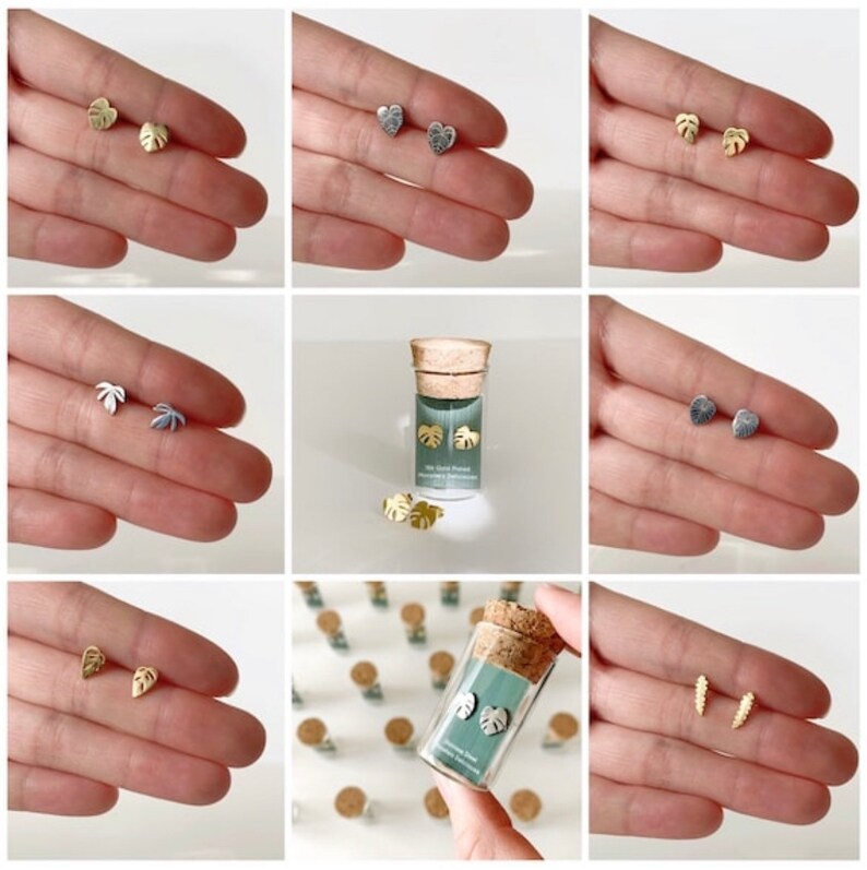 May include: A set of gold and silver earrings featuring a variety of leaf designs. The earrings are packaged in a small glass vial with a cork top. The vial has a label that reads "The Good Plant" and "Monstera Deliciosa".