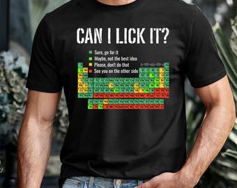 May include: Black t-shirt with the text "CAN I LICK IT?" above a colorful periodic table of elements. The shirt includes a key with the phrases "Sure, go for it," "Maybe, not the best idea," "Please, don't do that," and "See you on the other side."