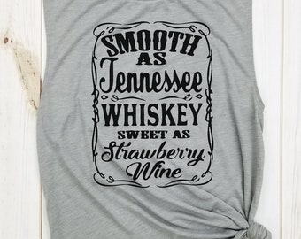 May include: Gray sleeveless muscle tank top with a black graphic print that reads "Smooth as Tennessee Whiskey Sweet as Strawberry Wine".