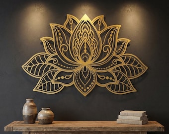 May include: A large, gold-colored lotus flower wall art piece with intricate cut-out details. The artwork is mounted on a dark gray wall, with a wooden table and decorative vases in the foreground. The lotus design is symmetrical and ornate.