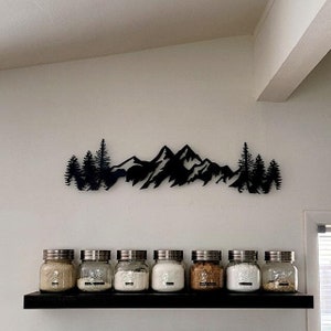 May include: A set of three ceramic mugs with a speckled, matte finish. The mugs are in shades of cream, light gray, and dark gray. Each mug has a simple, minimalist design and a rounded handle.